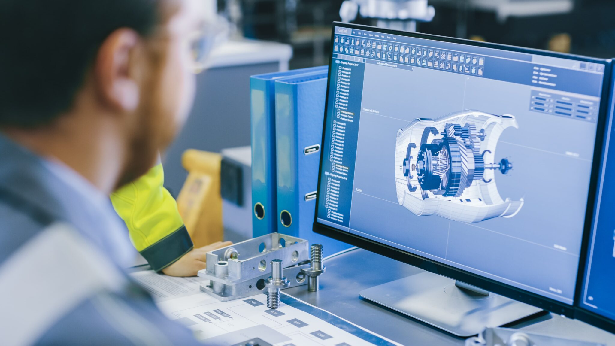 Engineer reviewing an exploded mechanical assembly in CAD software